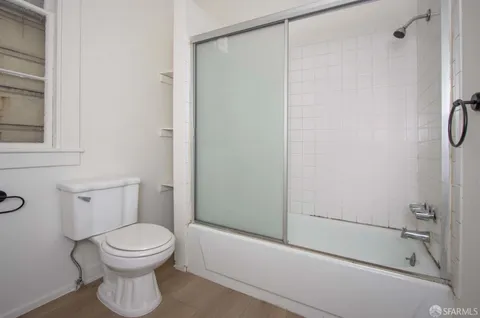 a bathroom with a toilet and a shower