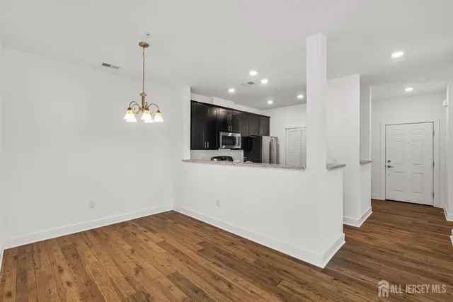 a view of a kitchen with wooden floor and a ceiling fan