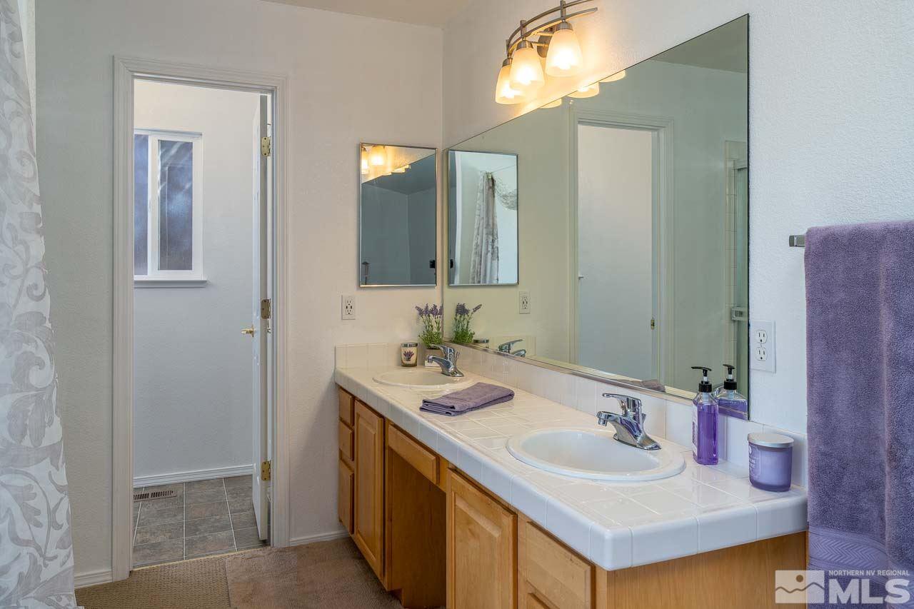 2139 Inca Dove Court Sparks, NV 89441 - Photo 13 of 25 a bathroom with a sink and a mirror