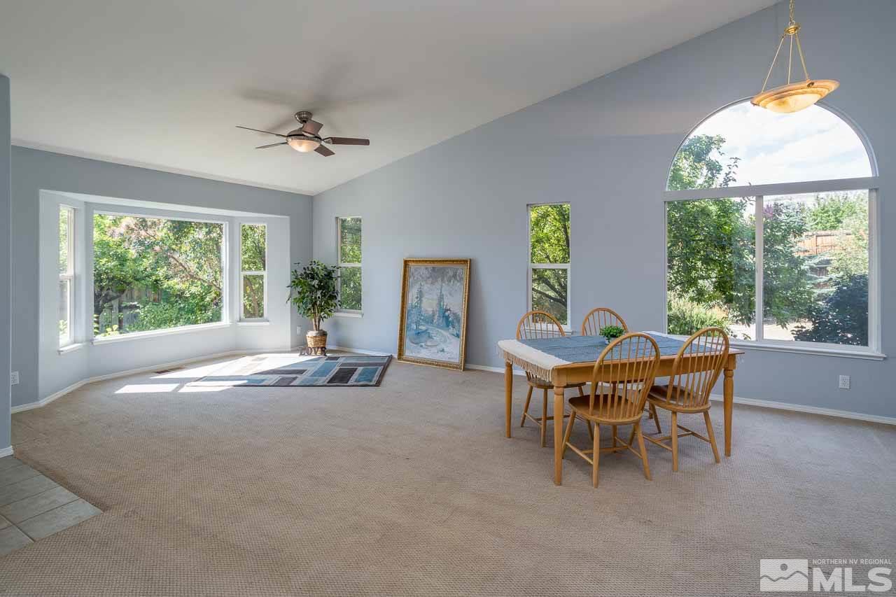 2139 Inca Dove Court Sparks, NV 89441 - Photo 2 of 25 a dining room with furniture a chandelier and a large window