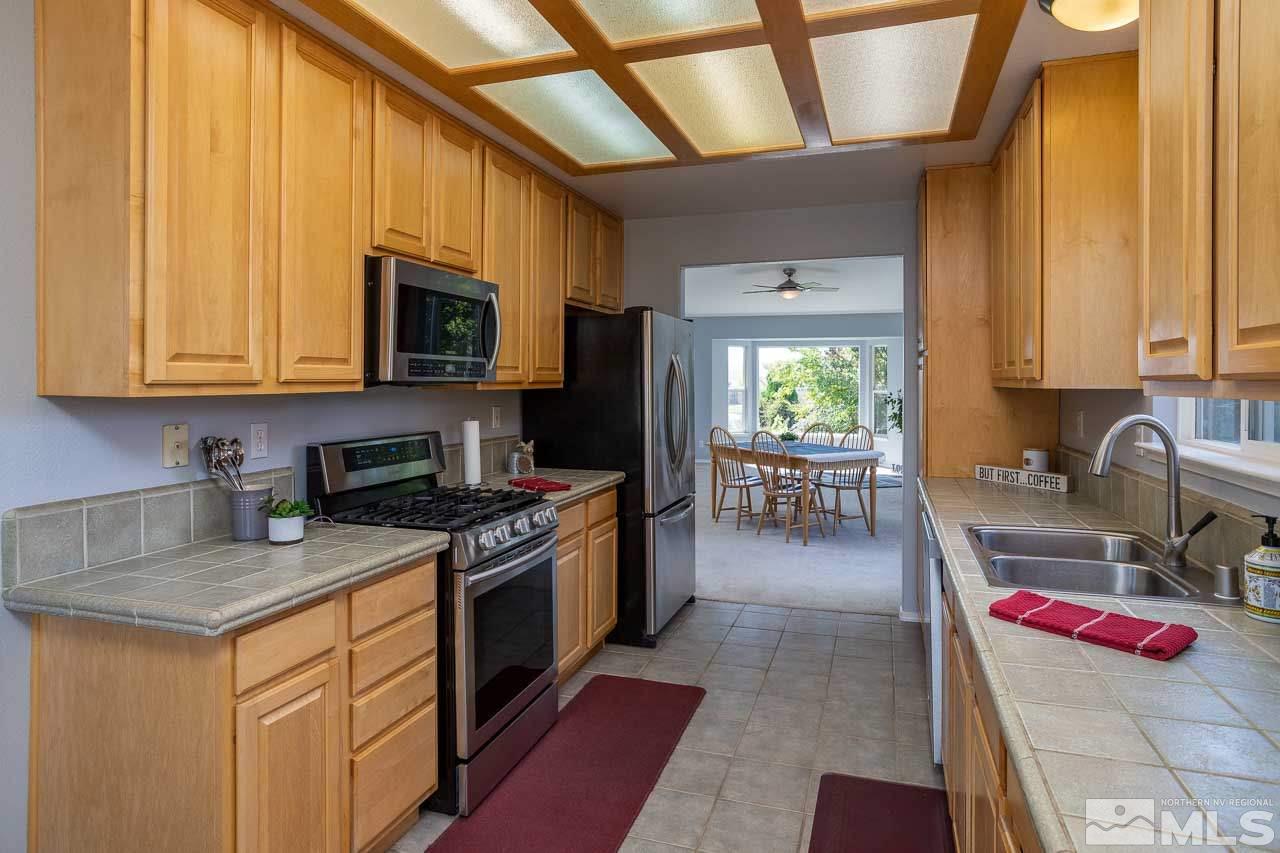 2139 Inca Dove Court Sparks, NV 89441 - Photo 5 of 25 a kitchen with a stove a sink and a microwave