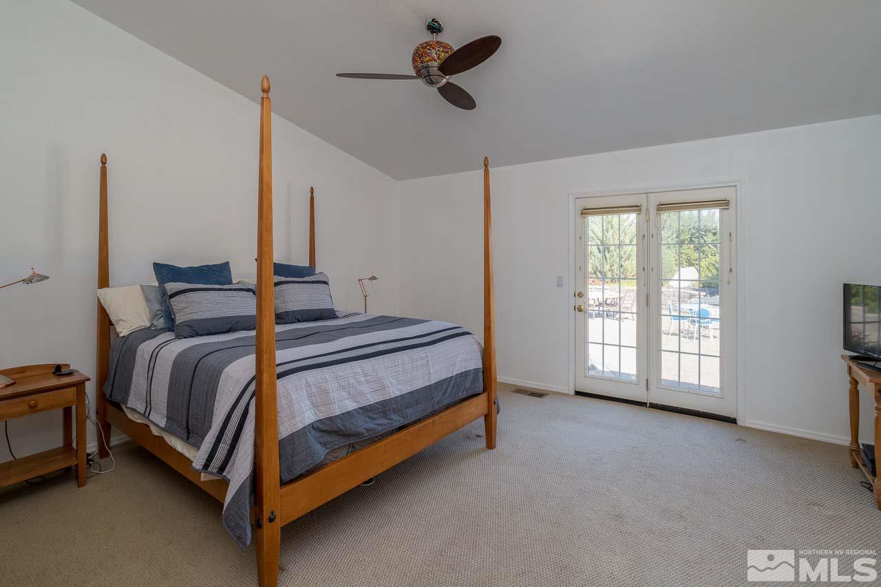 2139 Inca Dove Court Sparks, NV 89441 - Photo 10 of 25 a spacious bedroom with a bed and a ceiling fan