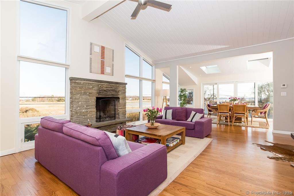 a living room with furniture wooden floor and a fireplace