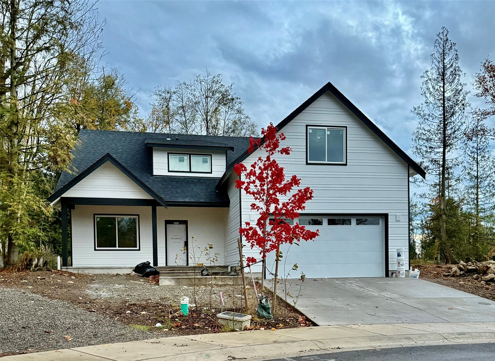 3052 Cedar View Road Blaine, WA 98230 - Photo 1 of 1 a front view of a house with a yard and garage