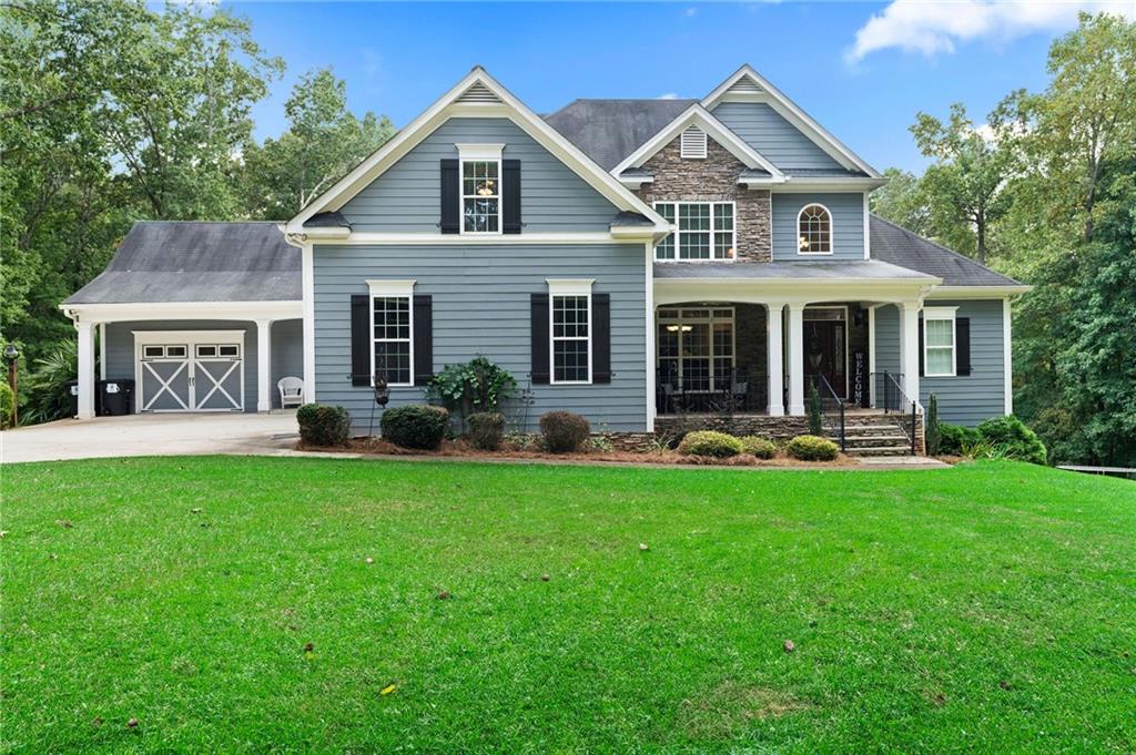 384 Woodland Path Dallas, GA 30132 - Photo 1 of 1 a front view of a house with yard and green space