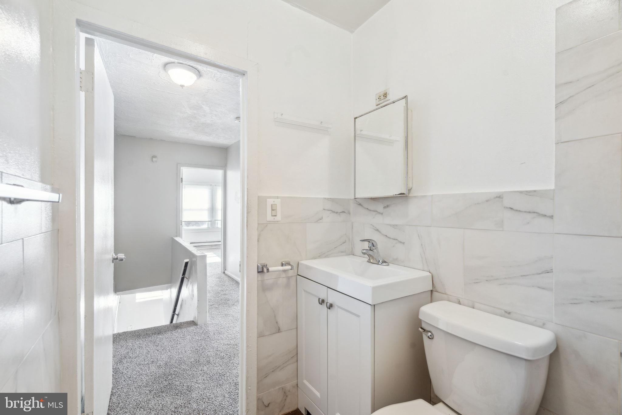 101 Pleasant Street Philadelphia, PA 19119 - Photo 16 of 43 a bathroom with a toilet sink and mirror