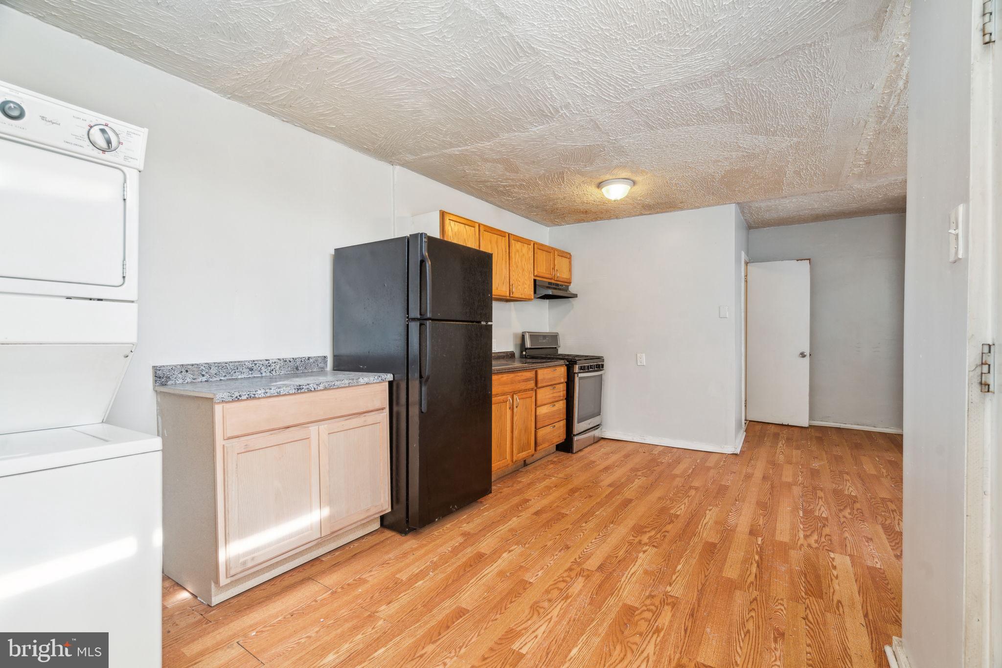 101 Pleasant Street Philadelphia, PA 19119 - Photo 3 of 43 a kitchen with granite countertop a refrigerator and a stove top oven