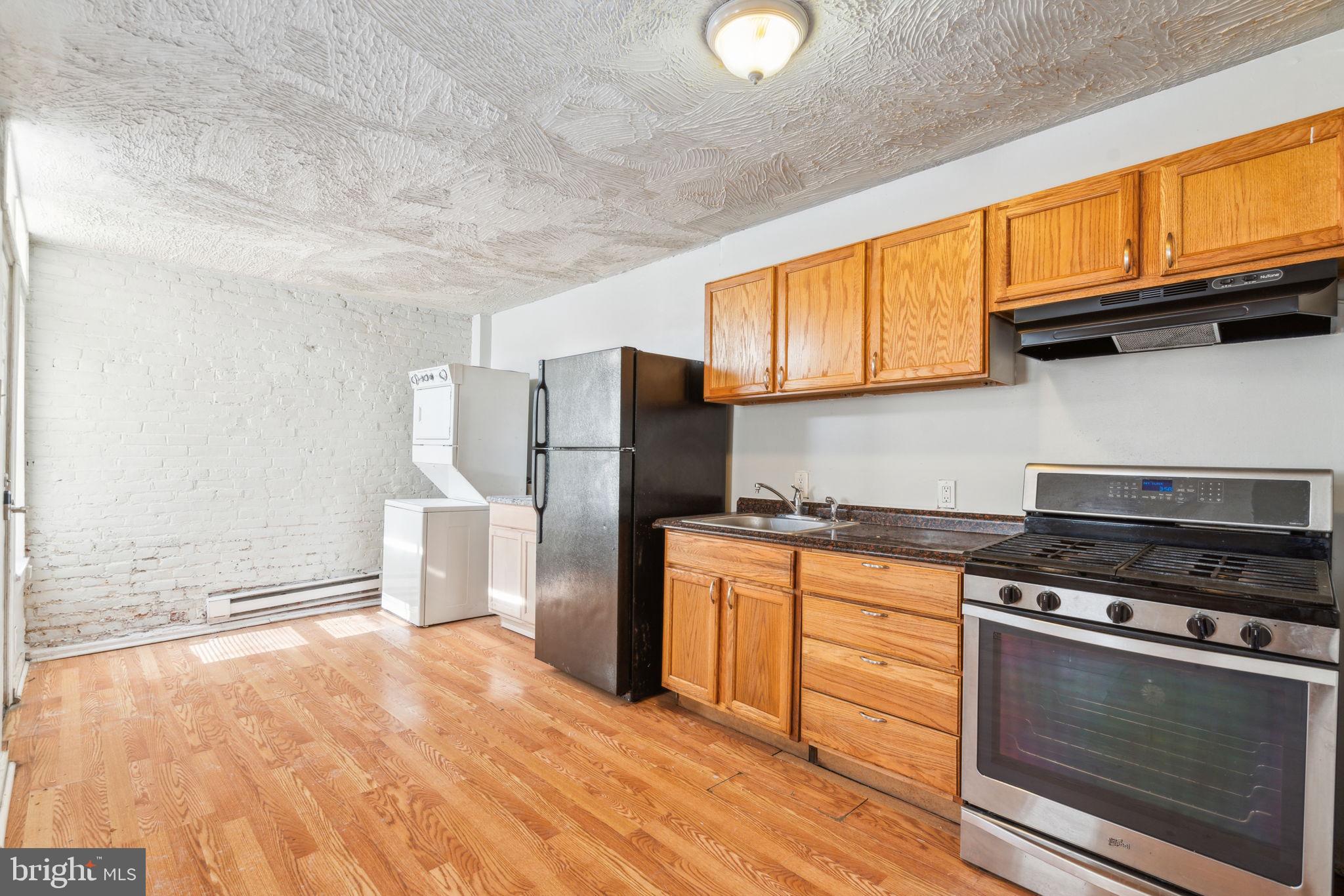 101 Pleasant Street Philadelphia, PA 19119 - Photo 5 of 43 a kitchen with stainless steel appliances granite countertop a stove a refrigerator and a microwave