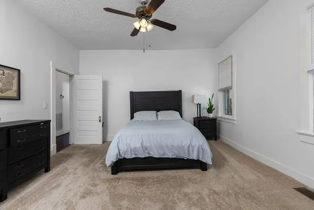 a bedroom with a bed and a tv