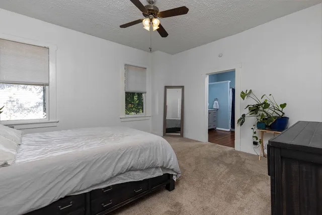 a bedroom with a bed and a potted plant