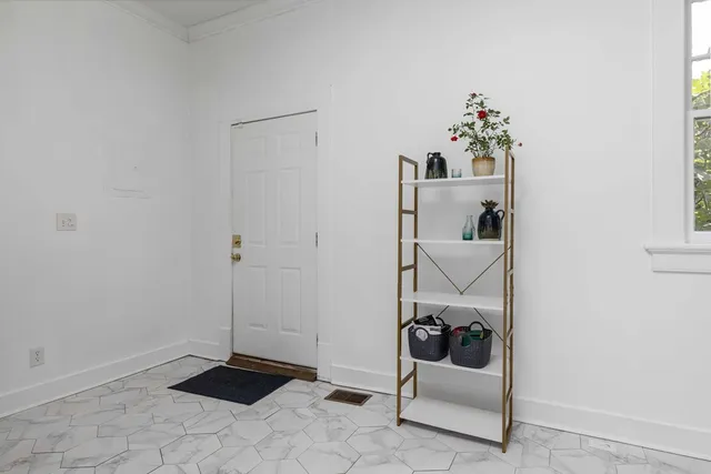 a walk in closet with window in back of it