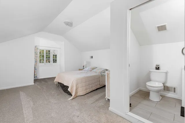 a spacious bedroom with a bed and a table