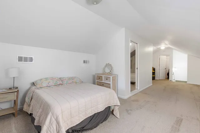 a bedroom with a bed and a lamp