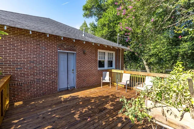 a view of wooden house with a large window