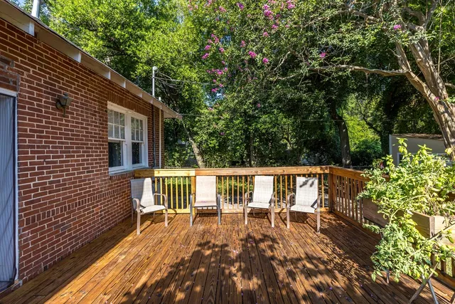 a view of balcony with wooden floor and fence