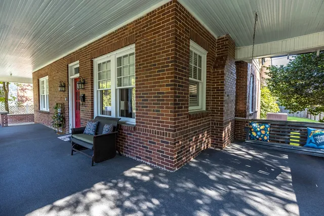 a backyard of a house with outdoor seating