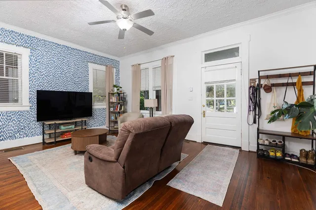 a living room with furniture and a flat screen tv