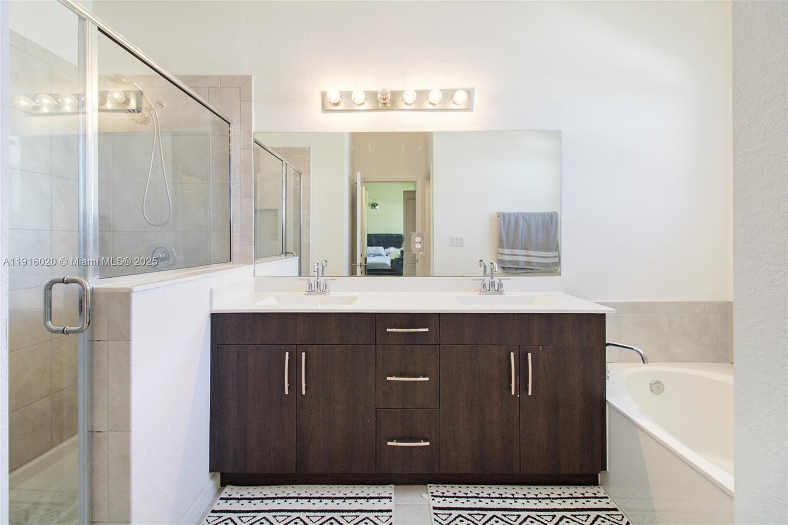 13251 Southwest 274th Terrace Homestead, FL 33032 - Photo 16 of 36 a bathroom with a sink a mirror and a bathtub