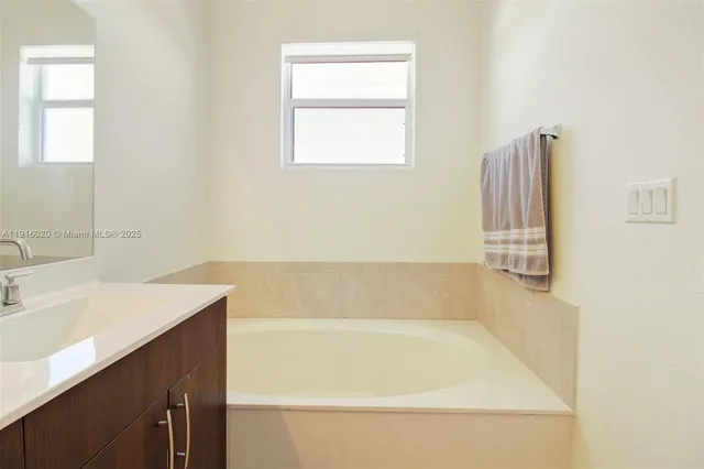 a bathroom with a bathtub and a sink