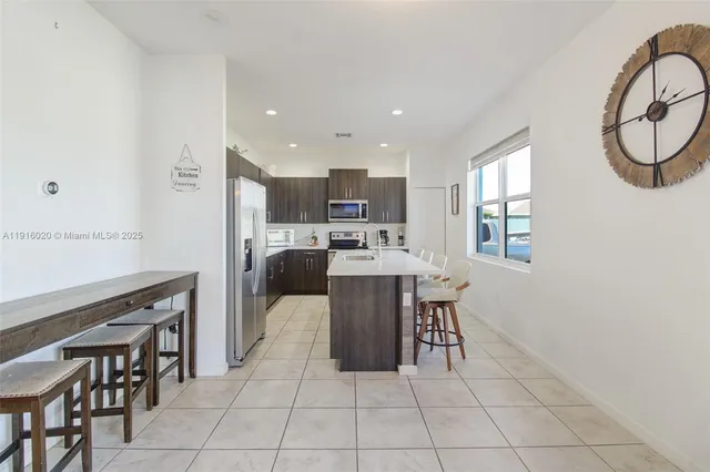 a kitchen with a table and chairs in it
