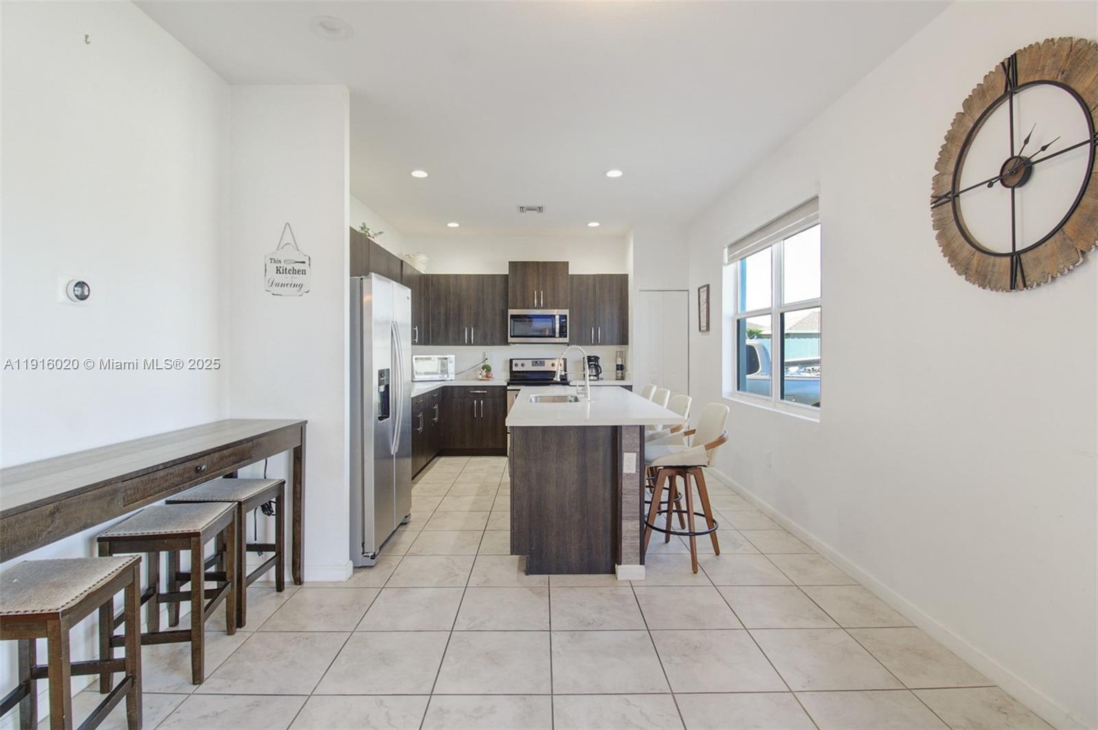 13251 Southwest 274th Terrace Homestead, FL 33032 - Photo 3 of 36 a kitchen with a table and chairs in it