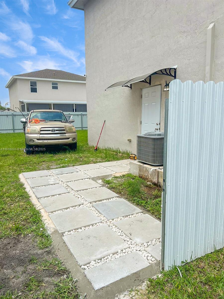13251 Southwest 274th Terrace Homestead, FL 33032 - Photo 36 of 36 a view of a car in front of a house