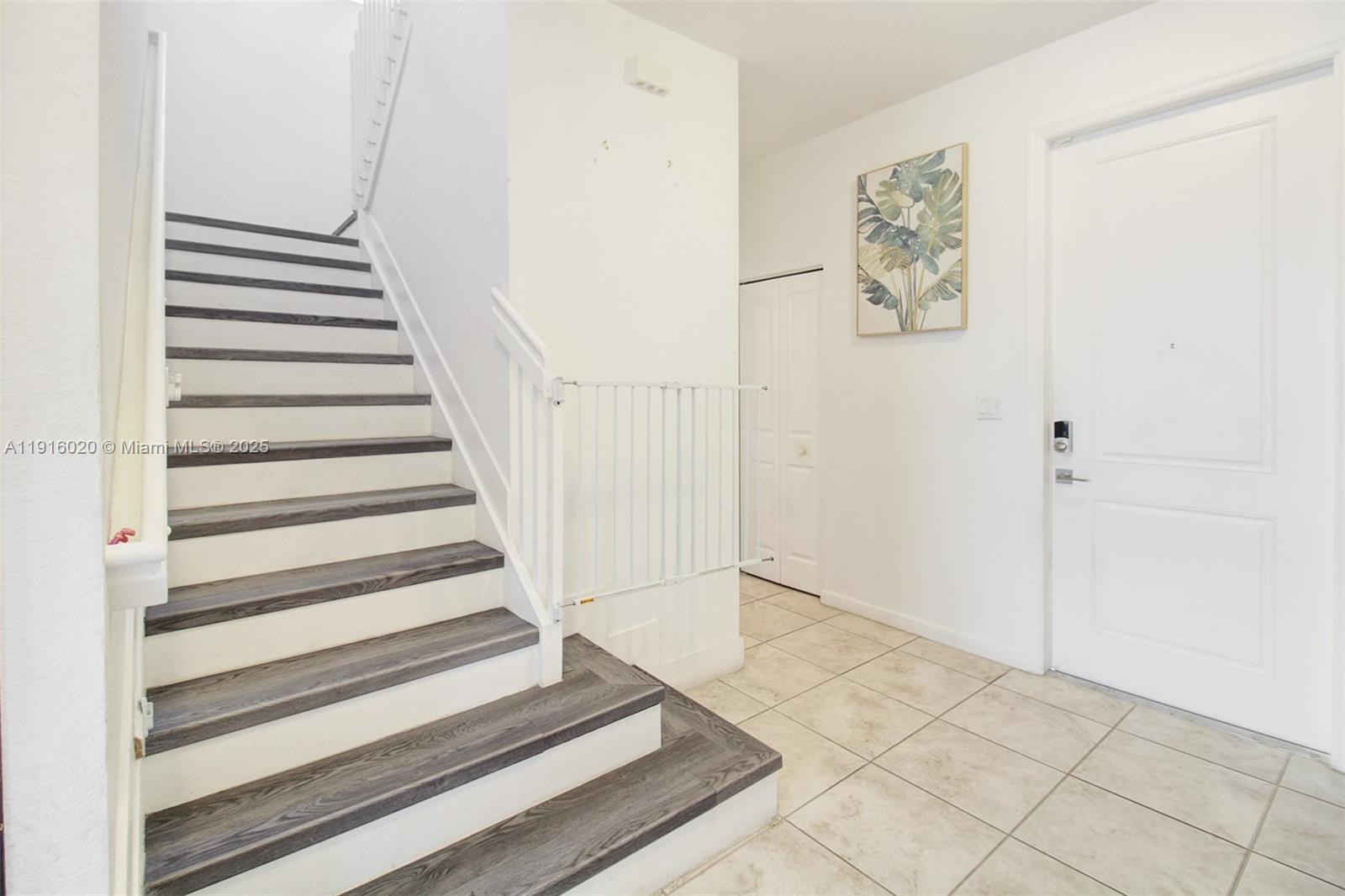 13251 Southwest 274th Terrace Homestead, FL 33032 - Photo 9 of 36 a view of a hallway with stairs and white walls