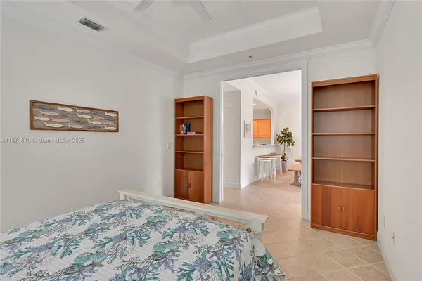 a bedroom with a large bed and a dresser