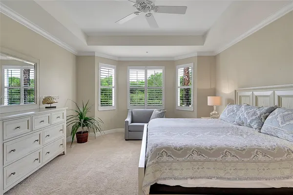 a bathroom with a granite countertop sink a mirror and a toilet