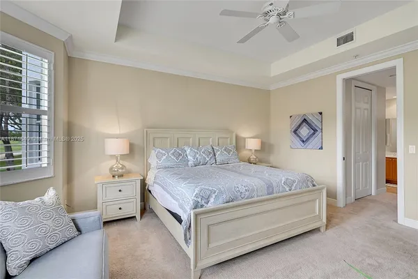 a bedroom with two beds and window