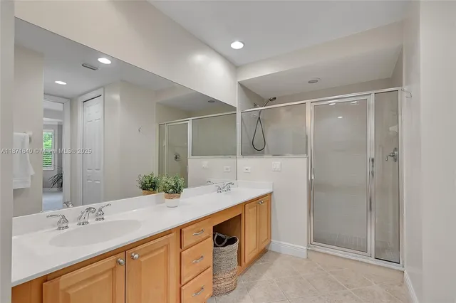 a bathroom with a granite countertop sink a toilet and shower
