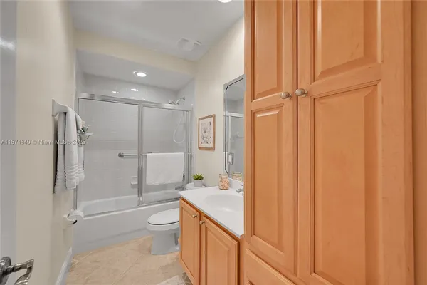 a dining room with furniture and a floor to ceiling window