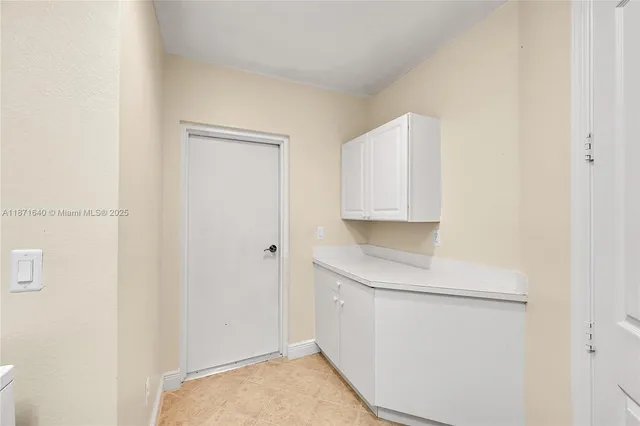 a view of a yard with plants and palm trees