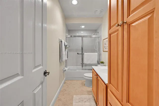 a view of a white house with a yard and a car parked beside it