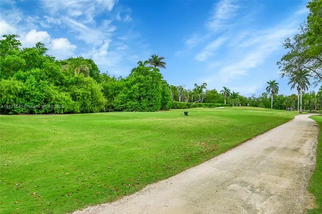 an aerial view of a city with lots of residential buildings ocean and mountain view in back