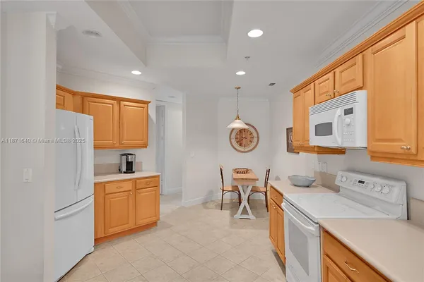 a living room with furniture a chandelier and a table