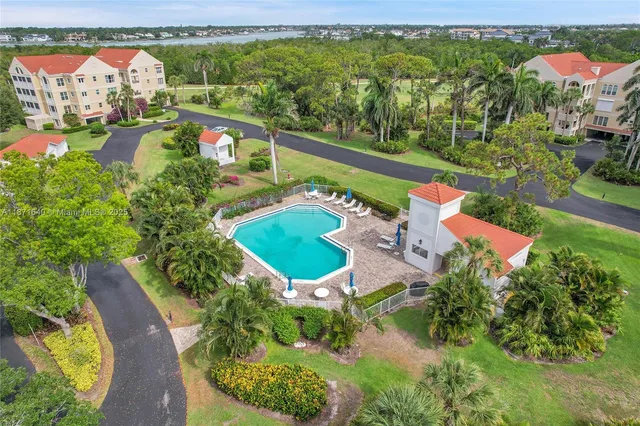 an aerial view of a house with outdoor space and lake view