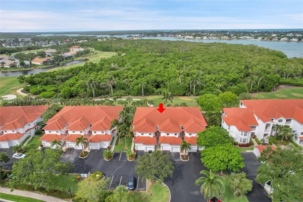 an aerial view of residential houses with outdoor space and lake view