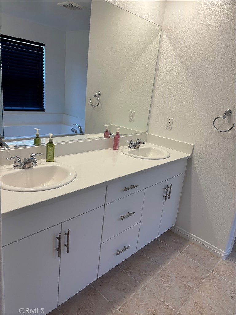 1375 Yeager Avenue Rialto, CA 92376 - Photo 10 of 12 a bathroom with a sink and a mirror