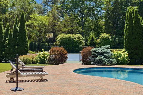 a view of a house with swimming pool and porch