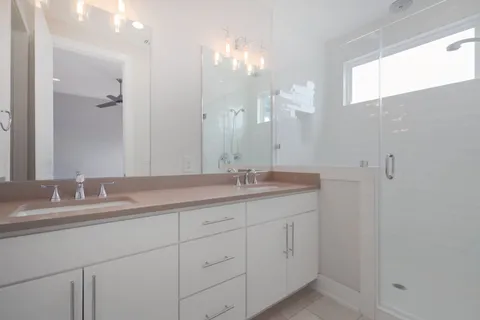 a bathroom with a double vanity sink and a mirror