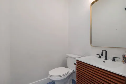 a white toilet sitting next to a bathroom sink