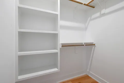 a view of walk in closet with clothes
