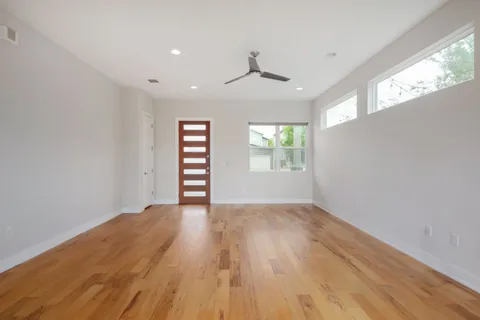 wooden floor in an empty room with a window