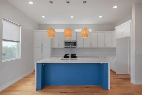 a kitchen with stainless steel appliances granite countertop a sink and a cabinets