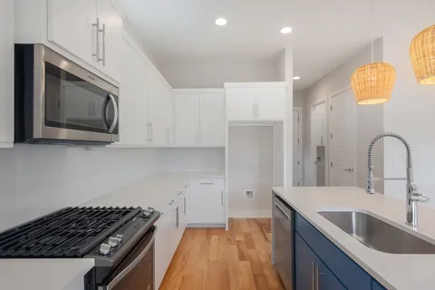 a kitchen with granite countertop a stove and a sink