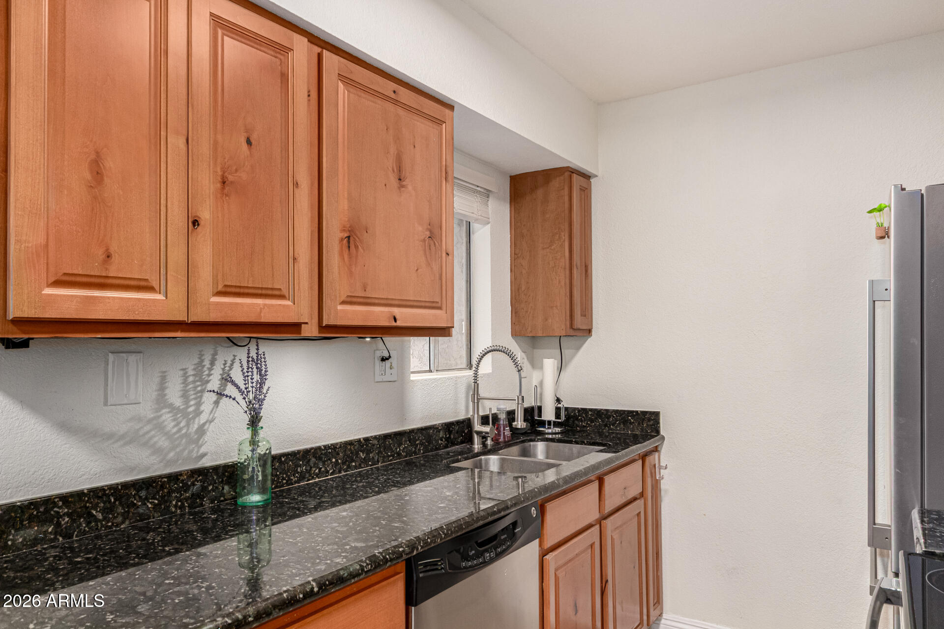 5877 North Granite Reef Road, Unit 1133 Scottsdale, AZ 85250 - Photo 12 of 33 a kitchen with granite countertop a sink and cabinets