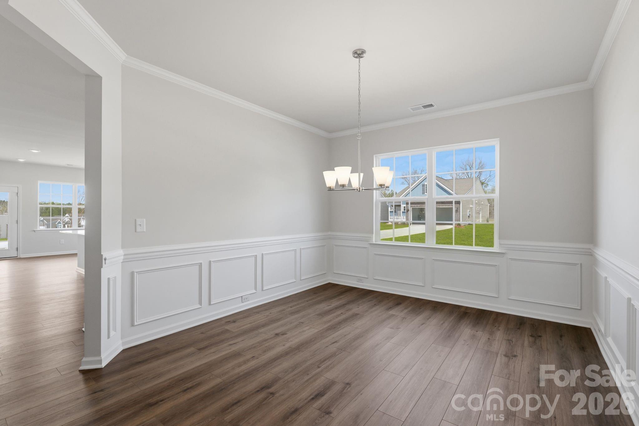 5475 Redbud Road, Unit 57 Lancaster, SC 29720 - Photo 18 of 30 a view of empty room with wooden floor and fan