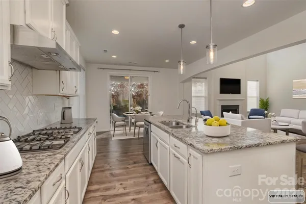 a large kitchen with a table and chairs