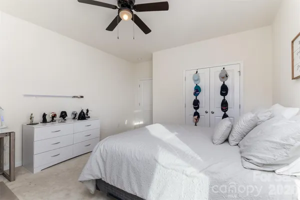 a bedroom with a bed and a potted plant